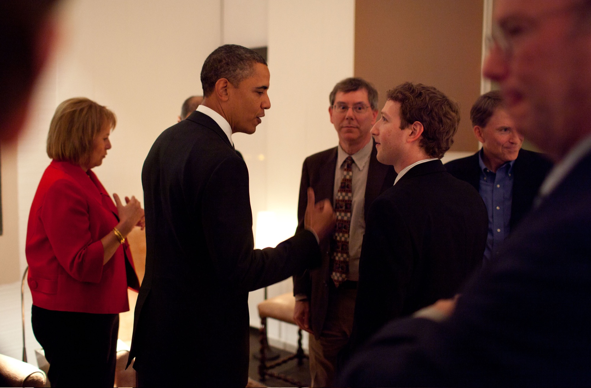 President Barack Obama and Facebook CEO Mark Zuckerberg speaking face to face.